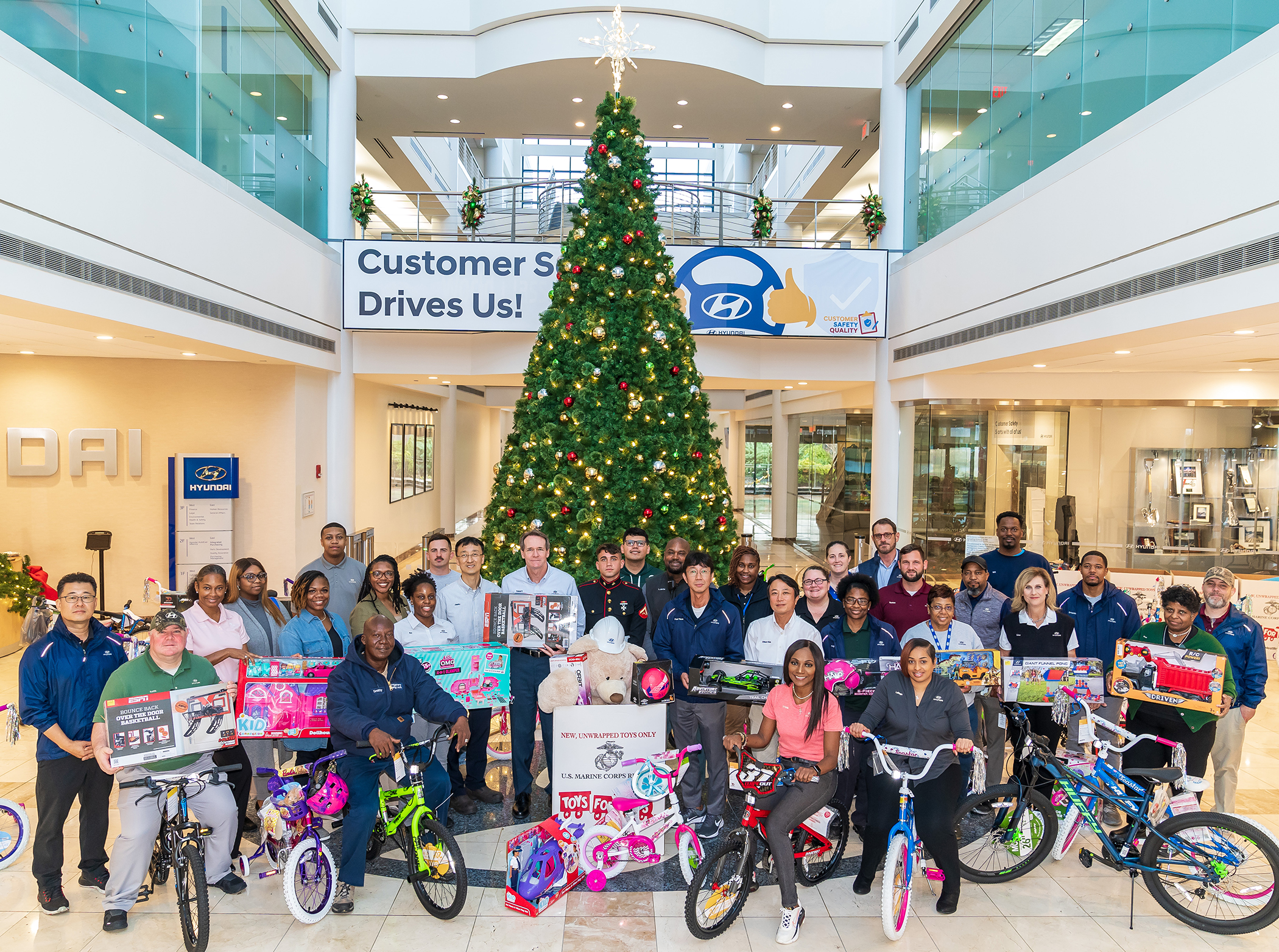 HMMA TEAM MEMBERS DONATE BICYCLES AND TOYS TO MARINE CORPS TOYS FOR TOTS AND MONTGOMERY HOUSING AUTHORITY